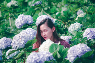 Smiling woman by flowering plants