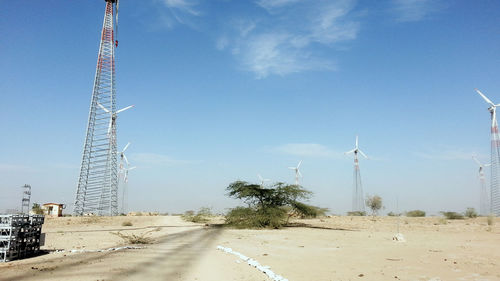 View of windmill on landscape against sky