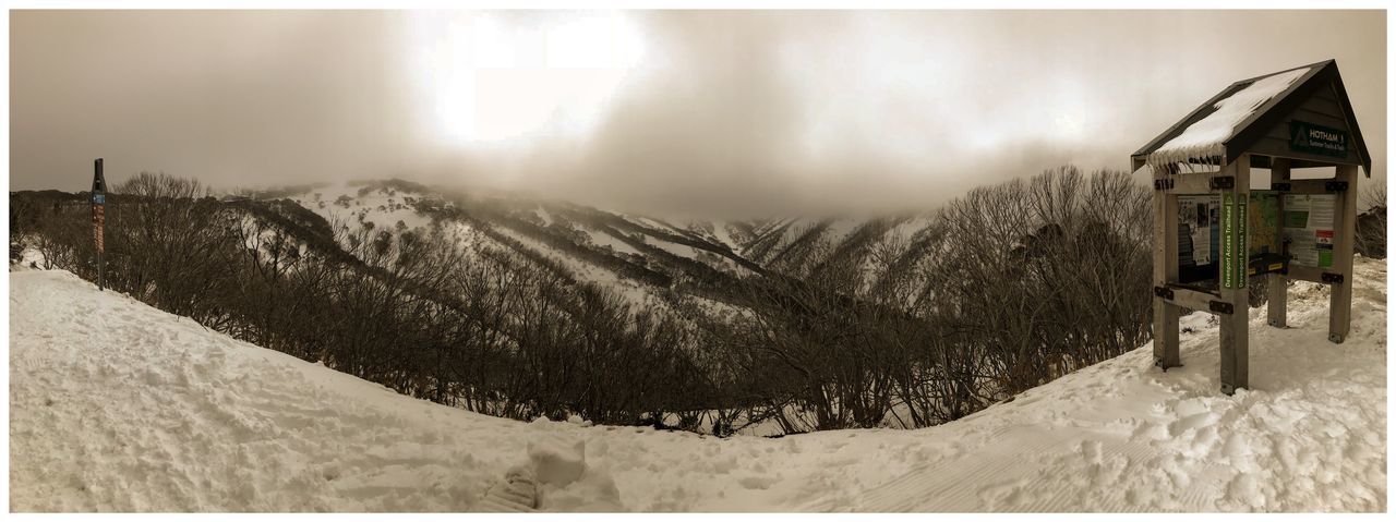 SNOW COVERED MOUNTAINS AGAINST SKY