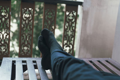 Low section of man relaxing on bench