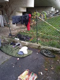 High angle view of shoes on footpath by street in city