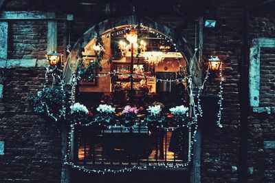 Illuminated lanterns hanging at store