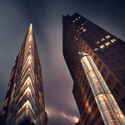 Low angle view of skyscrapers against sky at potsdamer platz in city during night