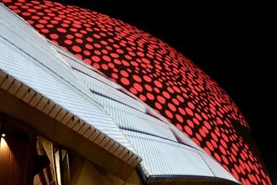 Low angle view of modern building against sky at night