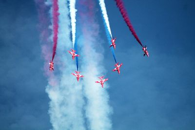 Low angle view of airshow against sky