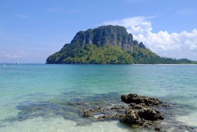 Scenic view of rocks in sea against sky