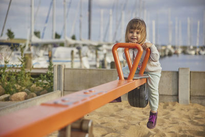 Charming child swings on a playground in denmark