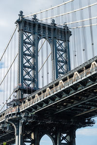 Low angle view of manhattan bridge against sky