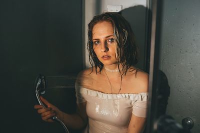 Portrait of woman taking shower in bathroom