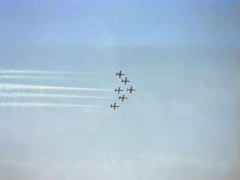 Low angle view of airplane flying against sky