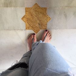 Low section of woman sitting at home