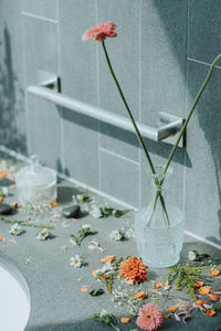 Close-up of flower vase against glass wall