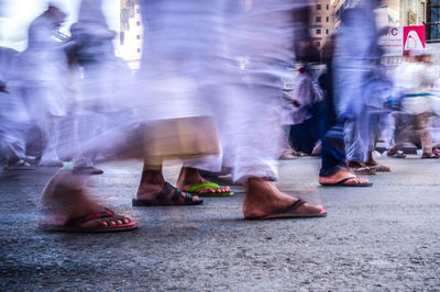 Low section of people standing on street