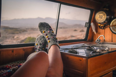 Low section of woman relaxing in motor home