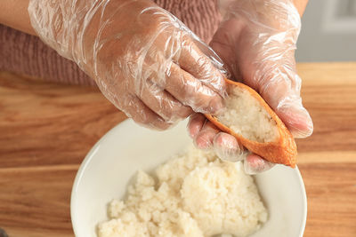 Cropped hand of person preparing food