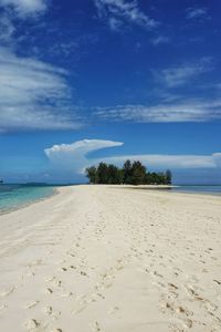 Scenic view of beach against blue sky