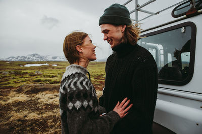 Man and woman standing in bus during winter