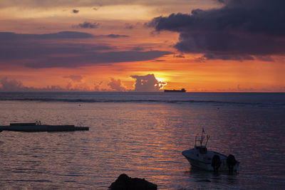 Fishing boat during sunset at albion beach, mauritius.