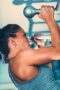 Side view of woman exercising in gym