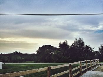 Scenic view of field against cloudy sky