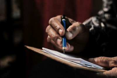 Close-up of man working in pen