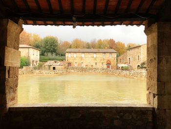 View of old building by lake in tuscany