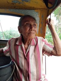 Senior woman sitting in land vehicle