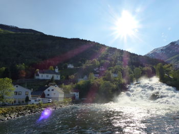 River amidst mountains against sky