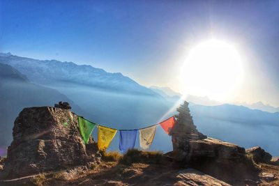 Scenic view of mountains against bright sun