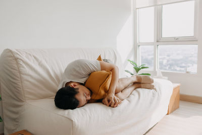 Tired man resting on sofa at home