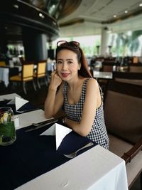 Portrait of smiling woman sitting at restaurant