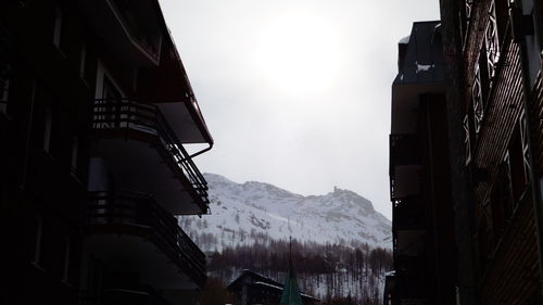 Panoramic shot of buildings and mountains against sky