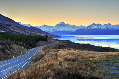 Scenic view of sea and mountains against clear sky