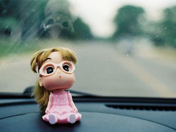 Close-up of toy in car window