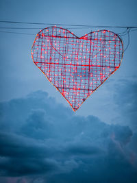 Low angle view of heart shapes on blue sky
