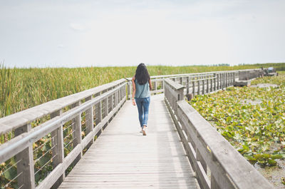 Rear view of woman walking on walkway