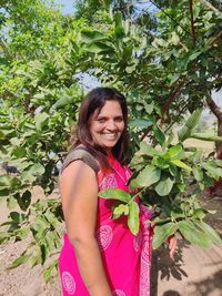 Portrait of a smiling young woman standing outdoors