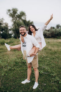 Young couple standing on field