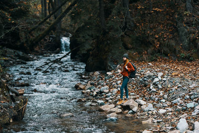 Man walking on rocks in forest