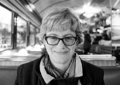 Portrait of smiling woman wearing eyeglasses at restaurant