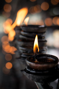 Close-up of lit candles in temple