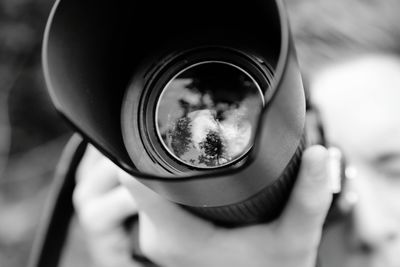 Reflection of person photographing