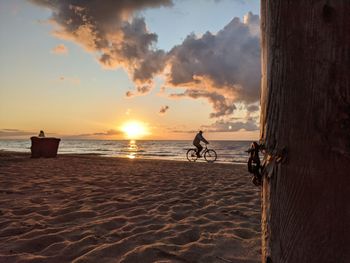 Scenic view of beach against sky during sunset