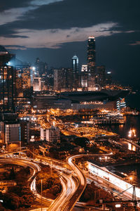 Aerial view of illuminated elevated roads and buildings at night