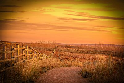 Scenic view of landscape against sky at sunset