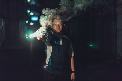 Boy holding illuminated sparkler