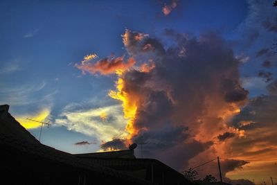 Low angle view of silhouette buildings against sky during sunset