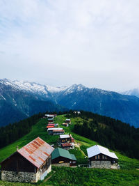 Houses on mountain against sky