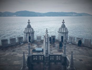 View of building by sea at dusk