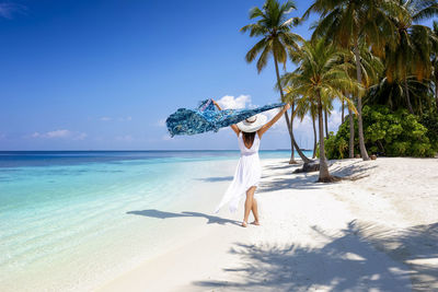 Full length of woman on beach against sky